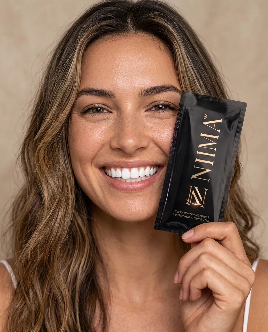 Woman holding a NIMA whitening strip sachet