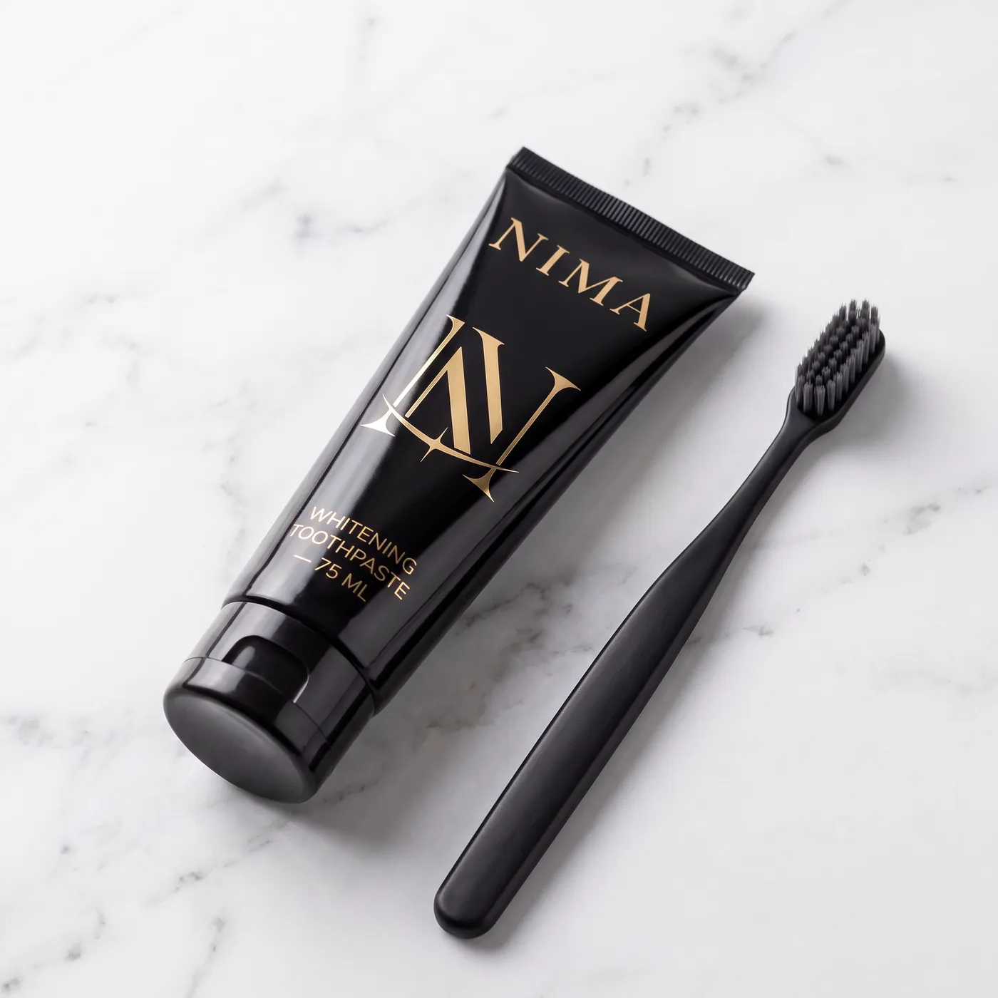 The NIMA toothpaste tube and brush on marble